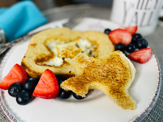 Two Medium Sized Ladies Texas Style Toad in the Hole Fried Egg and Toast Breakfast Plate served with strawberries and blueberries