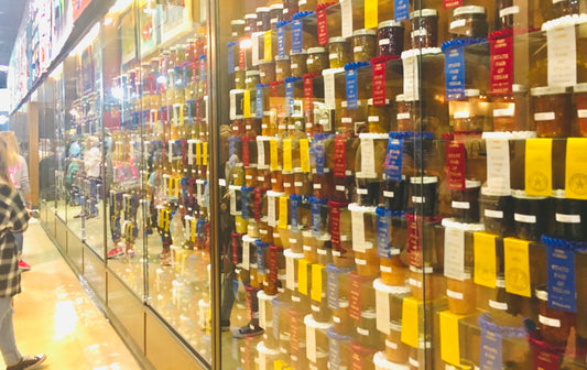 Two Medium Sized Ladies blue ribbon jams and jellies on display at the Texas State Fair
