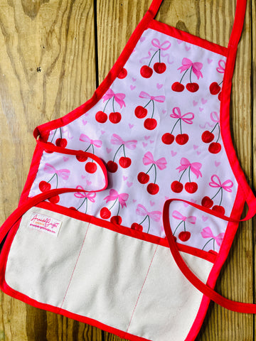 Amanda Bright Designs Children's Cherries and Bows Apron with red trim and strings trending