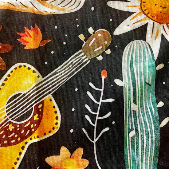 Amanda Bright Designs Delilah Apron with colorful western guitar cactus cowboy hat sunflower pattern on black background