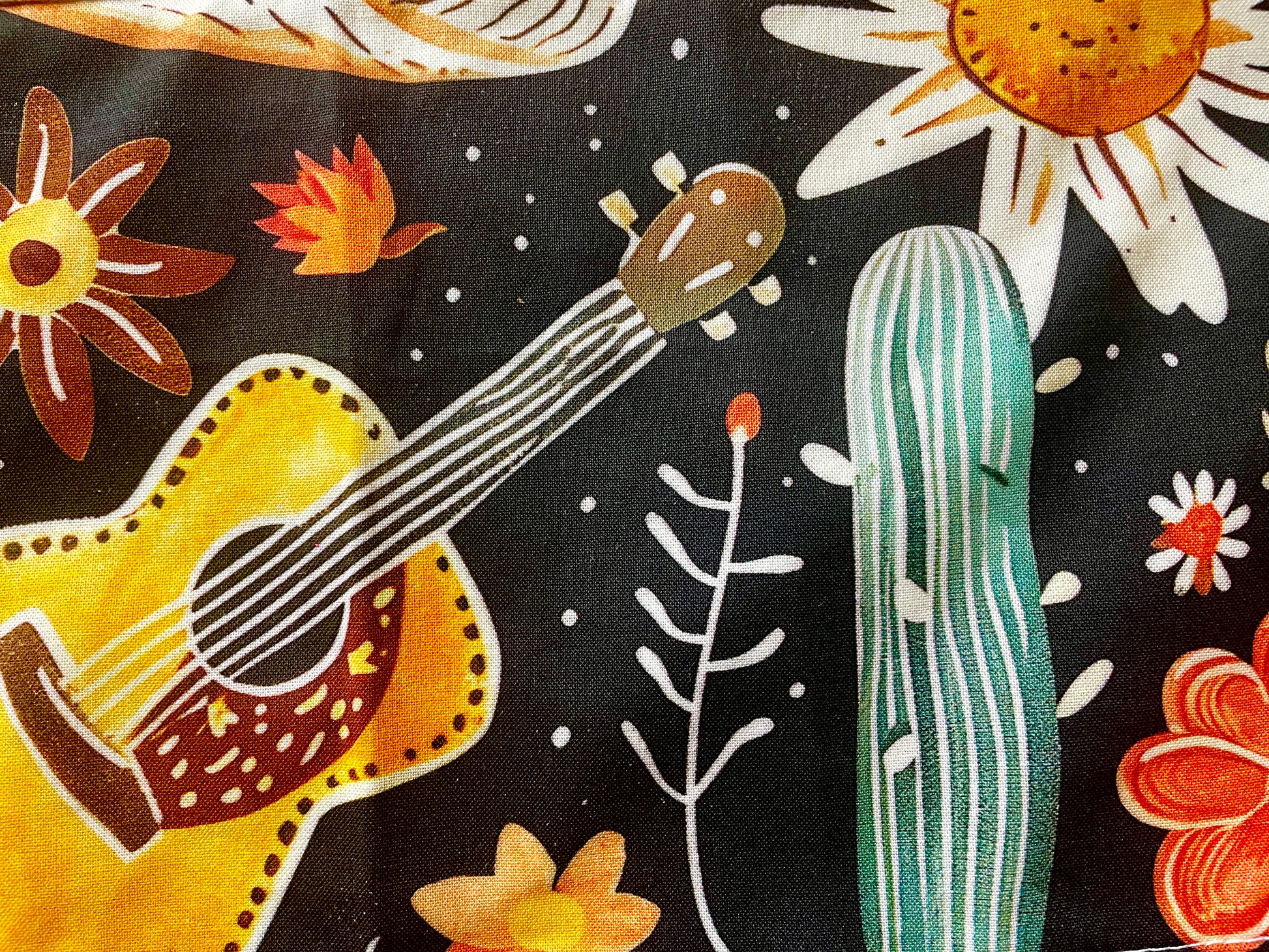 Amanda Bright Designs Delilah Apron with colorful western guitar cactus cowboy hat sunflower pattern on black background