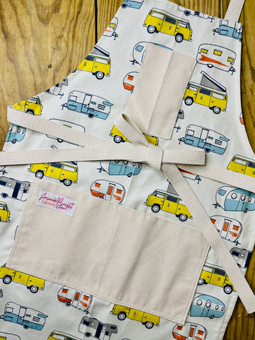 Amanda Bright Designs apron with camper and van pattern on a wooden surface