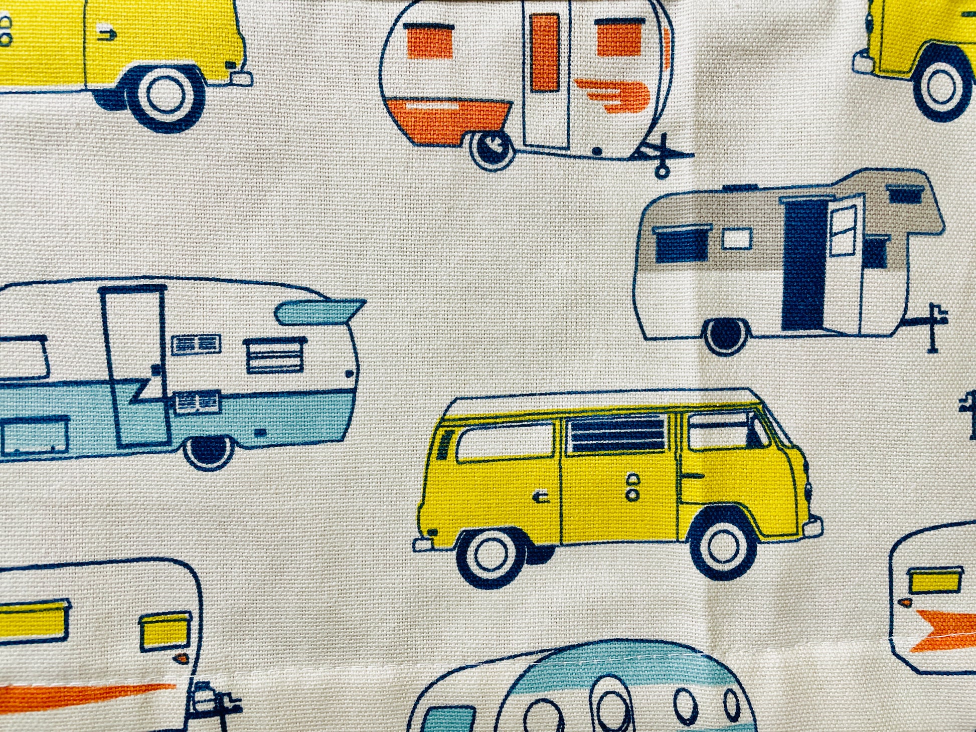 Amanda Bright Designs apron with camper and van pattern on a wooden surface