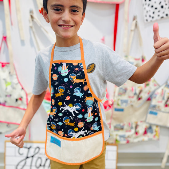 Two Medium Sized Ladies Children's apron space dogs exploration NASA shooting stars planets cosmos worn by little boy aged 10