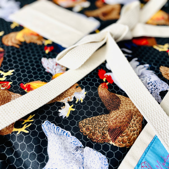 Two Medium Sized Ladies Kathleen Apron chickens wire coop raising farm close up view