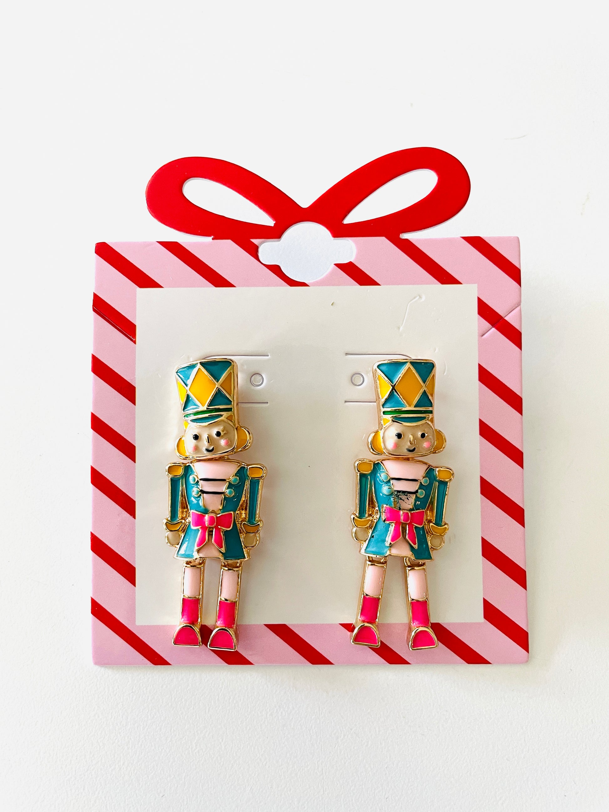 Amanda Bright Designs Pair of nutcracker-themed earrings on a red and white striped card.