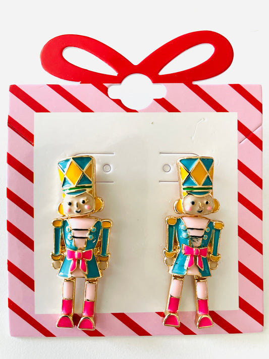 Amanda Bright Designs Pair of nutcracker-themed earrings on a red and white striped card.