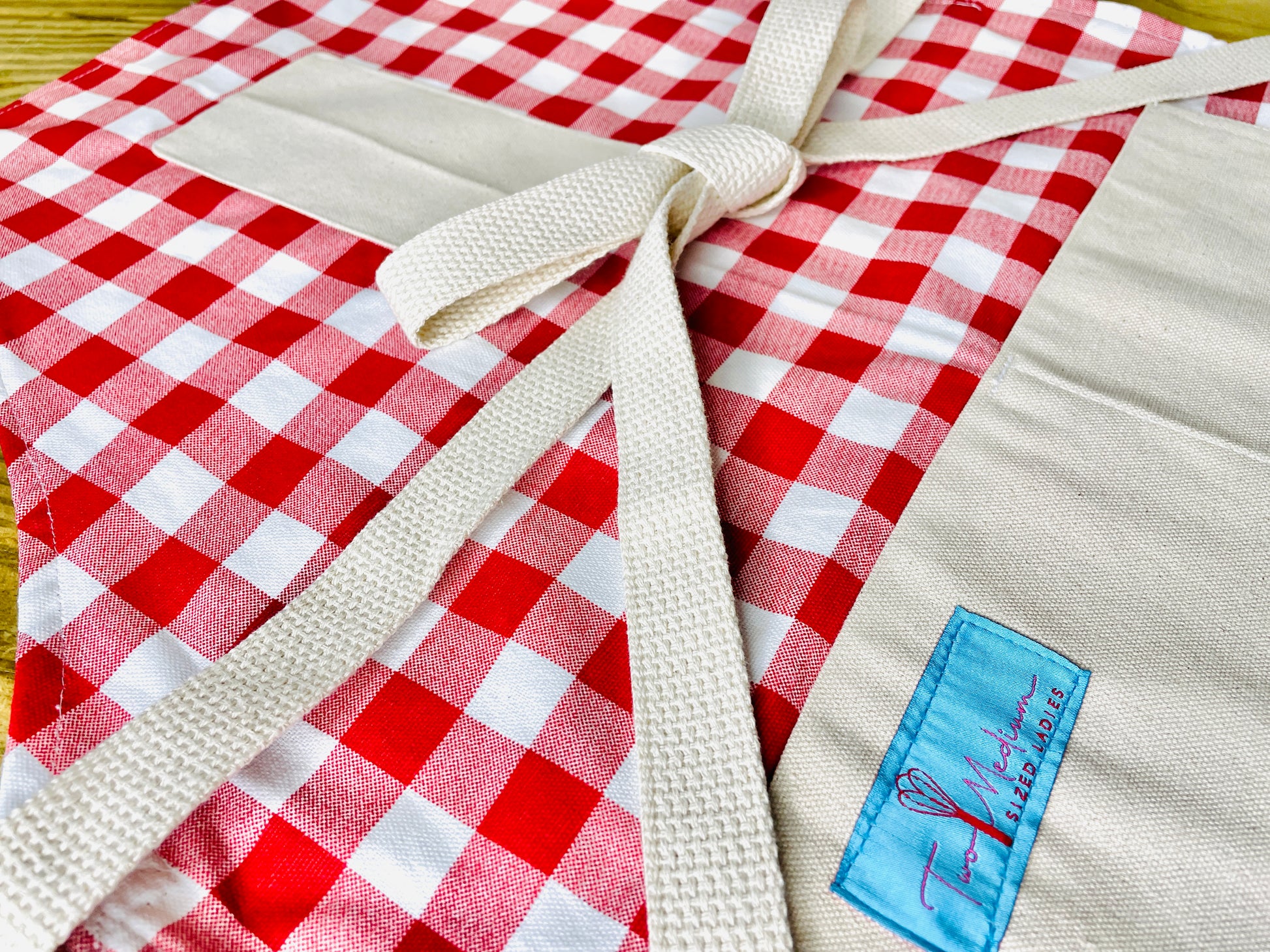 Wendy red checkered gingham apron tablecloth summer picnic Italian French bbq close up view