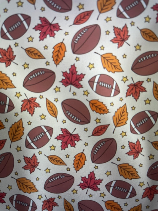 Footballs Fall leaves and stars on a cream background Sunday Apron Amanda Bright Designs Couture Collection