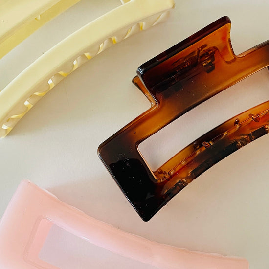 Amanda Bright Designs Three rectangular hair clips in beige, tortoiseshell, and pink on a white background