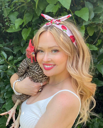 Amanda Bright Designs strawberry sundae summer headband for women of all ages holding chicken in her arms