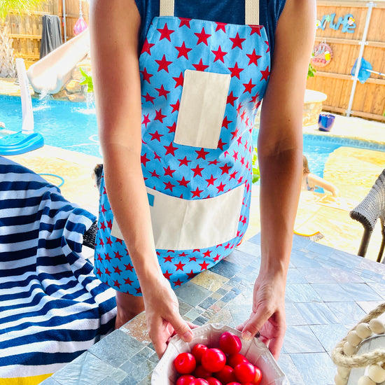 Two Medium Sized Ladies Betsy Ross kitchen apron fireworks stars and stripes American flag pattern fourth of july woman on her patio pool bbq grill backyard