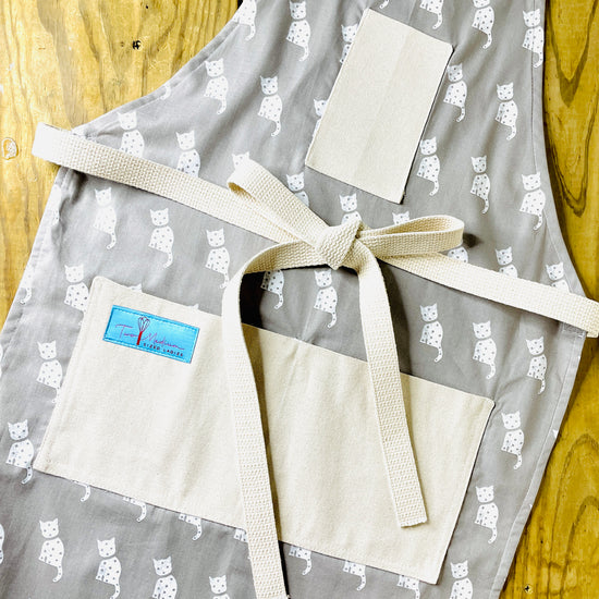 Two Medium Sized Ladies Cleo white cat gray background kitchen animal lovers apron farmhouse style