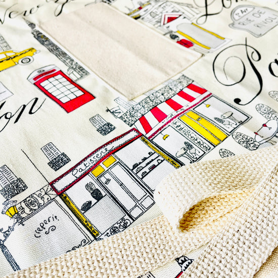 Two Medium Sized Ladies Evelyn Apron London New York City Paris skyscrapers cafe streets cityscape icon midcentury travel apron closeup view