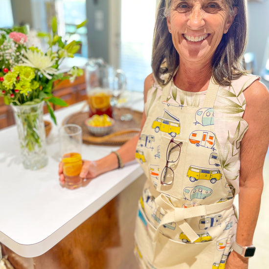 Amanda Bright Designs apron with camper and van pattern on a wooden surface