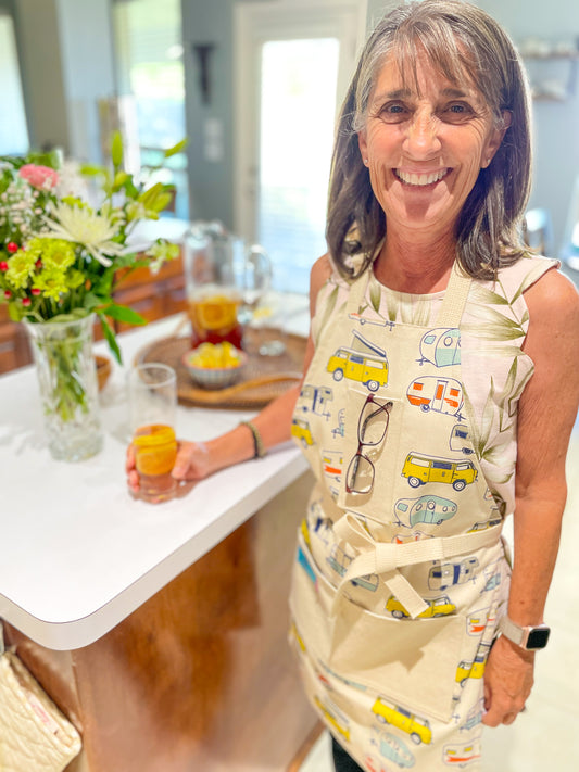 Amanda Bright Designs apron with camper and van pattern on a wooden surface