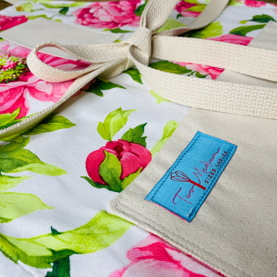 Two Medium Sized Ladies Priscilla Apron pink oversized peonies garden apron baking cooking retro designer garden flowers closeup view