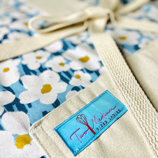 Two Medium Sized Ladies Lexie Kitchen Apron for crafts baking cooking fall seasonal garden floral handmade in Texas closeup view
