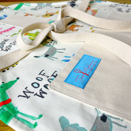 Two Medium Sized Ladies colorful playful dogs kitchen apron Maribeth